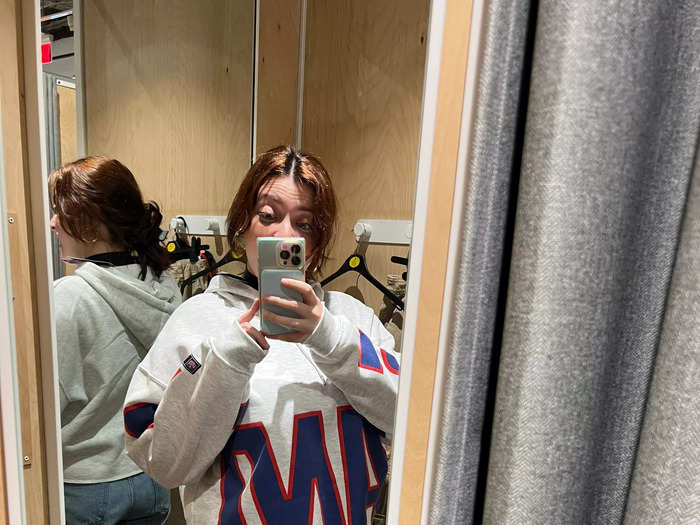 I tried on a few things — cargo pants that were too small, a dress that bunched weirdly, a trench coat that was too big and too dark — but I only liked this $20 cropped Giants hoodie.