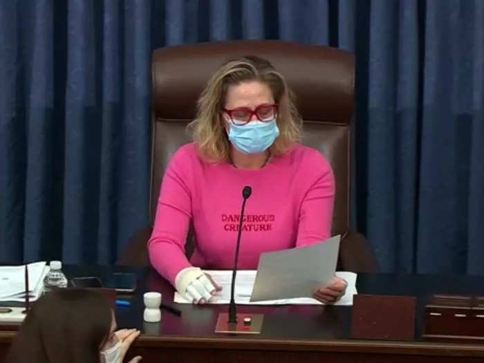 Sinema presided over the Senate in February 2021 while wearing a hot-pink sweater that read "Dangerous Creature."