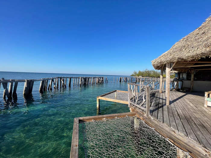 Here, bartenders mix piña coladas, mojitos, and other tropical drinks while guests relax on hammocks over the water. 