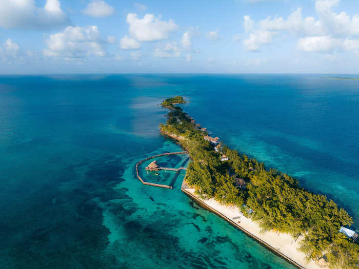 Hundreds of islands and resorts dot the coast of Belize, but Thatch Caye lured me with its overwater bungalows.