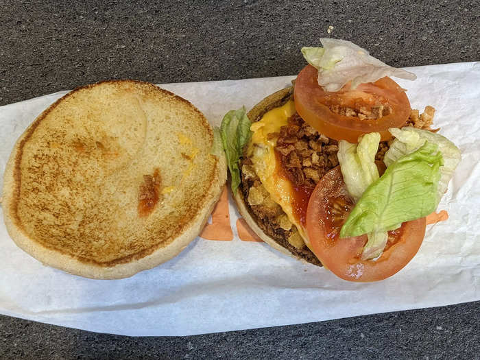 The burger consisted of a plain seedless bun, a bean patty, cheese, two slices of tomato, ketchup, a handful of crispy onions, lettuce, and mayo.