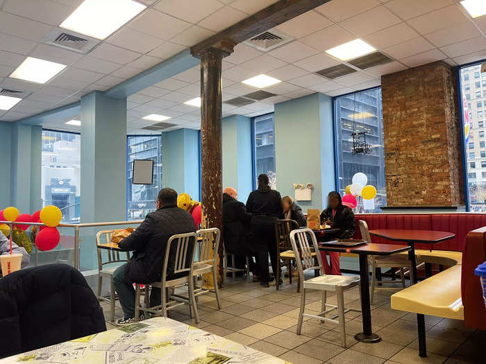 The New York City location had two levels. The stools by the windows downstairs were taken, so Erin went to the upstairs dining room, which was decorated with balloons.