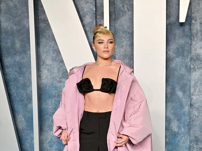 Pugh wore a bikini top with a statement coat to the Vanity Fair Oscars after-party in March 2023.