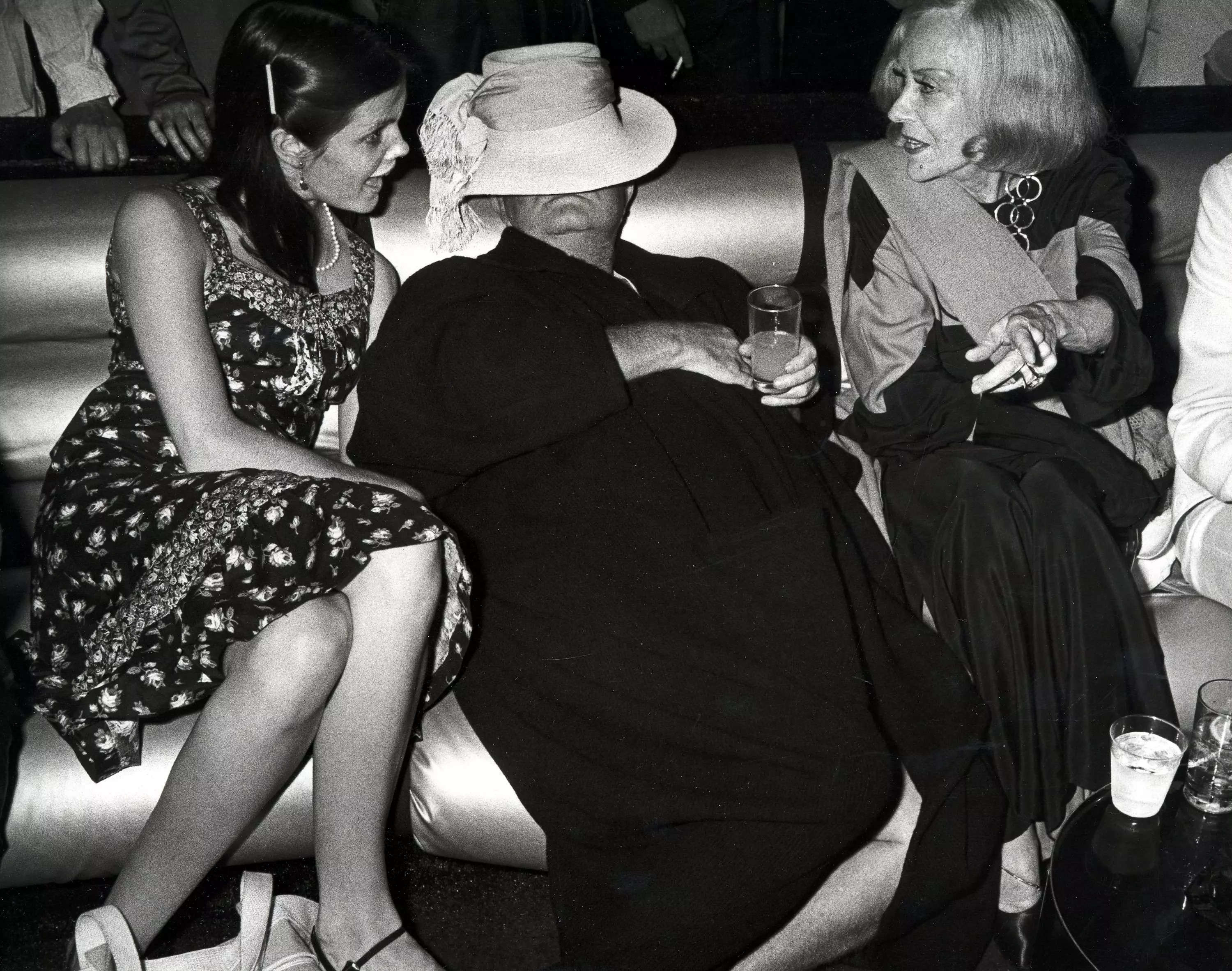 Kate Harrington talking to Gloria Swanson at a Studio 54 party in 1978, while Truman Capote rests in between them.