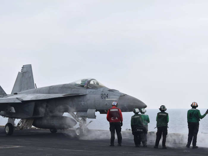 During a typical day on the Ike, dozens of planes may take off over multiple launch and recovery cycles that in total can last up to 12 hours — sometimes longer if needed.