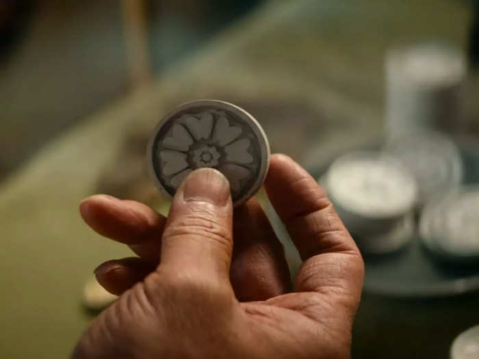 Iroh picks up a white lotus Pai Sho tile in a spot of foreshadowing. 