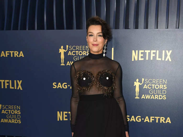 "The Crown" star Olivia Williams wore a floor-length black gown with a semi-sheer top.