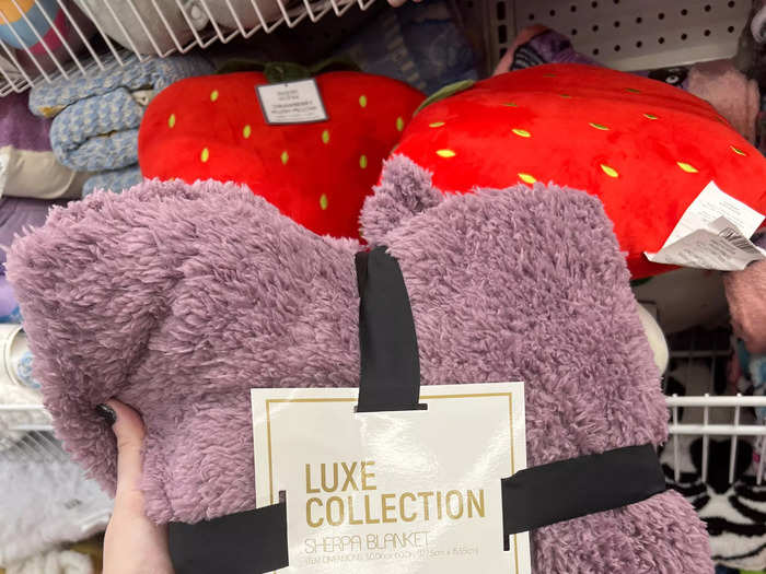 According to the site, the Luxe Collection sherpa blanket ($5.55) is a pretty solid dupe. They are similar in size and are both made of 100% polyester. That