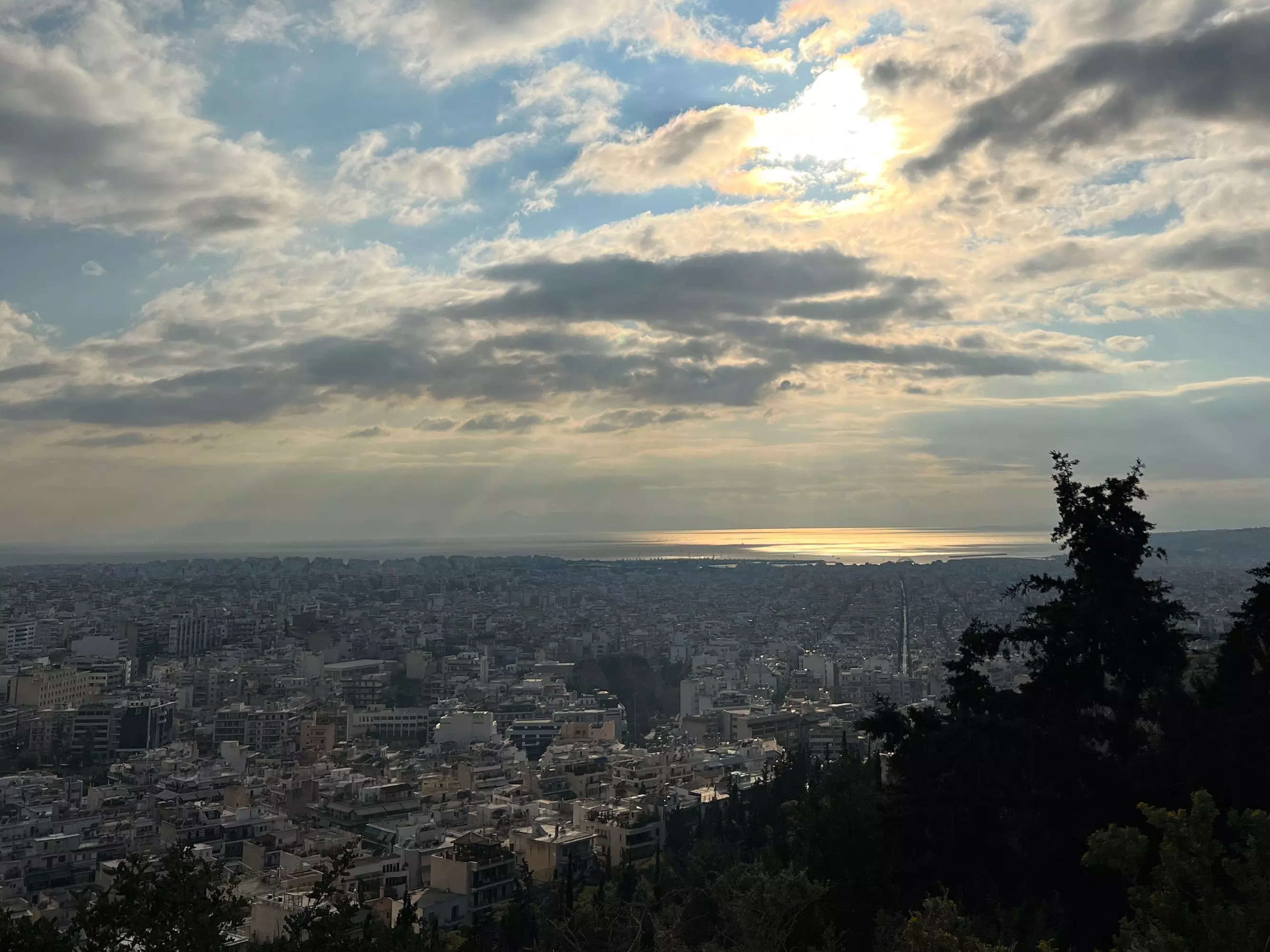 shot of the sun shining down on athens greece on a cloudy day