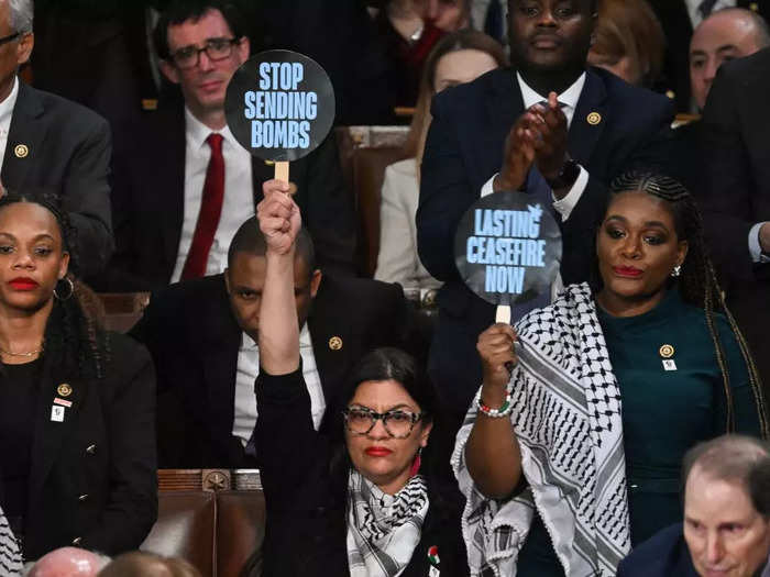 Reps. Rashida Tlaib and Cori Bush held signs calling for a ceasefire as Biden spoke about Israel and Gaza.