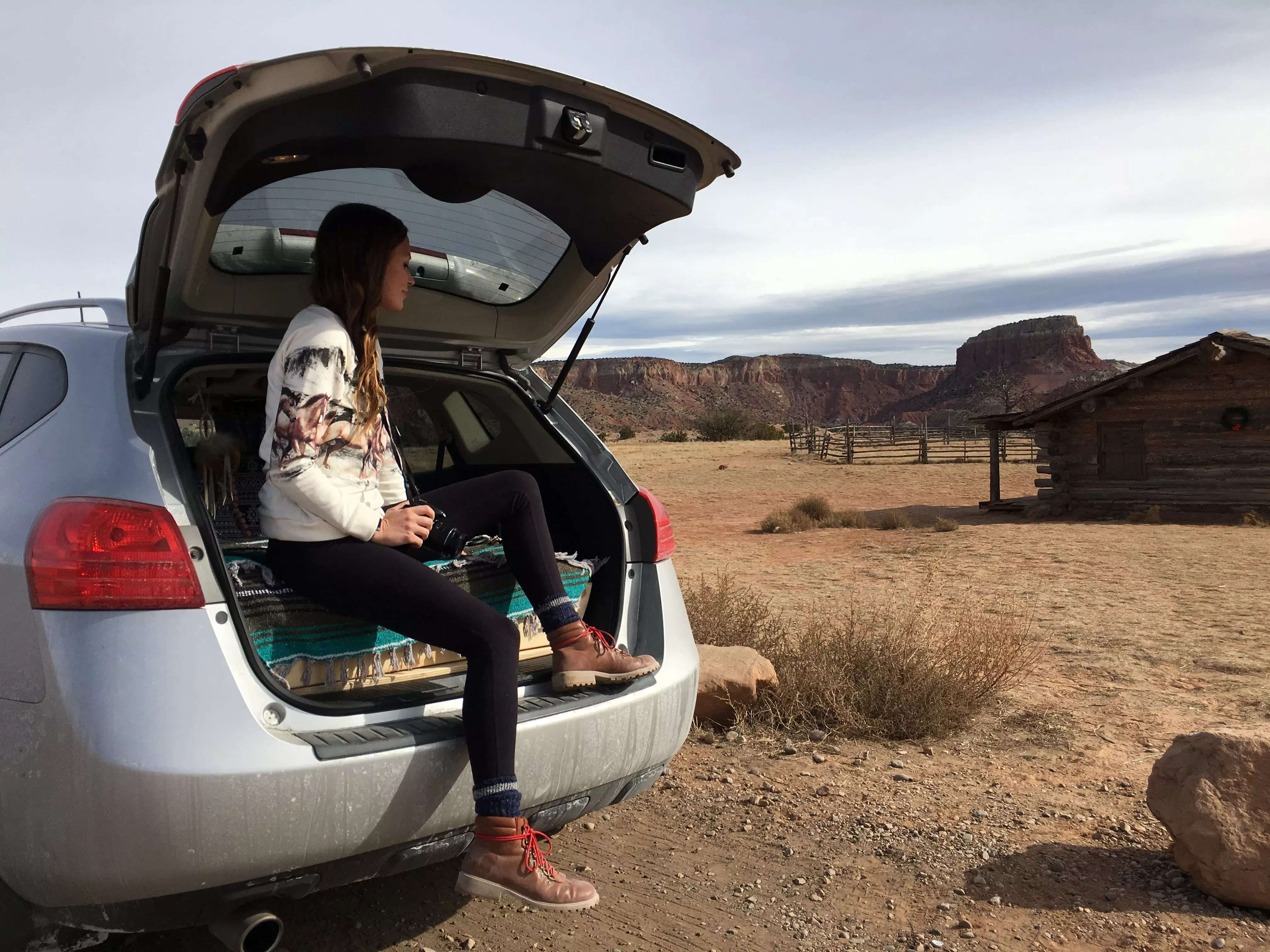 Emily sitting in the trunk of an SUV in New Mexico.