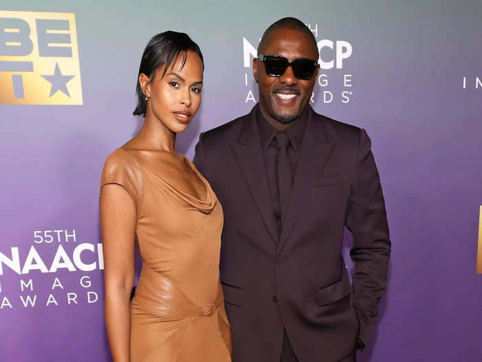 Idris Elba kept things classic with an all-black suit, while his wife, Sabrina Dhowre Elba, wore a floor-length tan dress.
