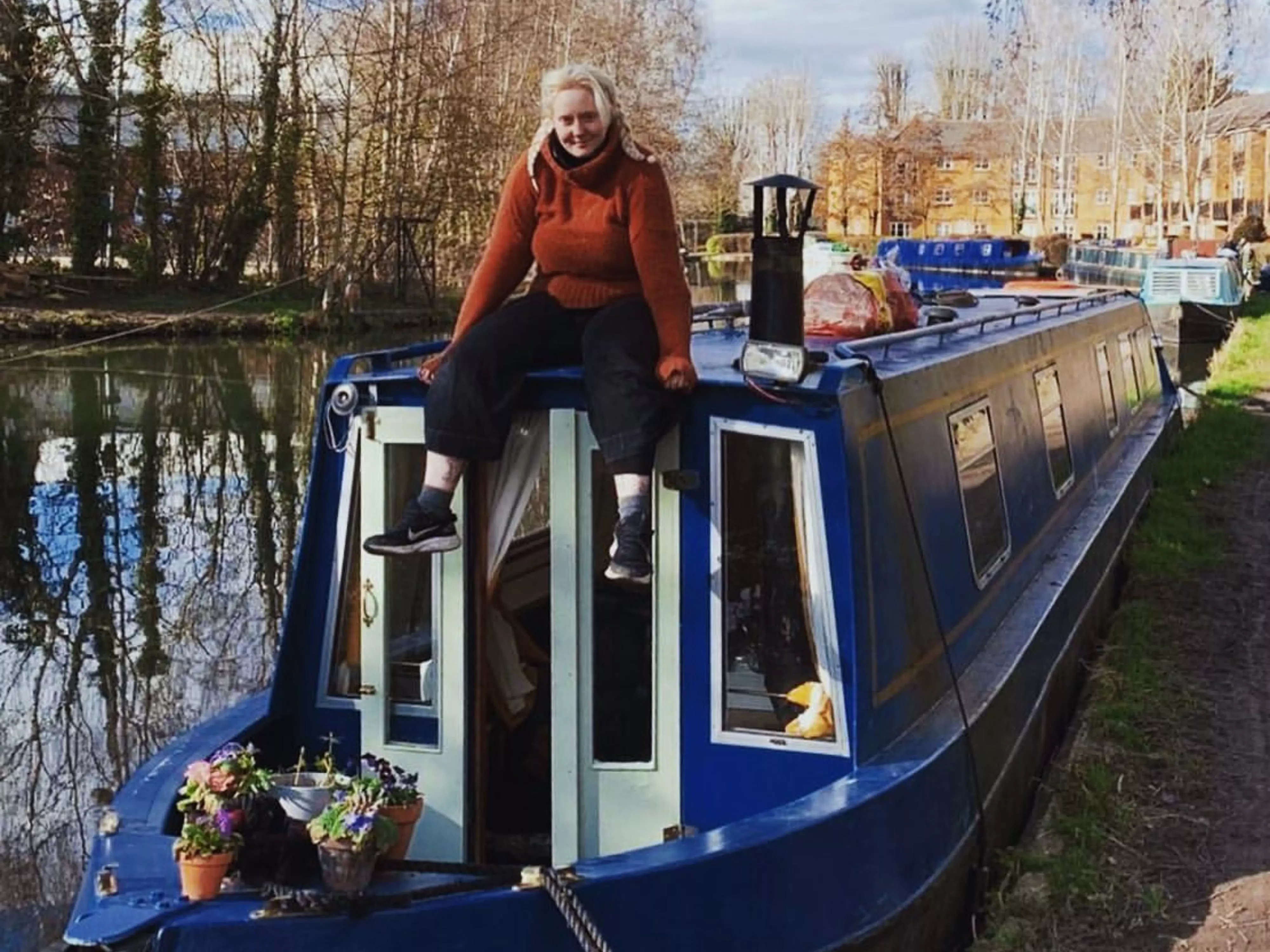Laura Woodley sitting on her narrowboat.