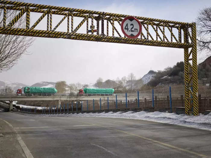 Trucks crossing a border bridge connecting Changbai, China, and Hyesan, North Korea.