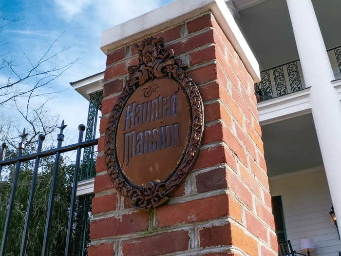 The front gate labels the home "The Haunted Mansion."