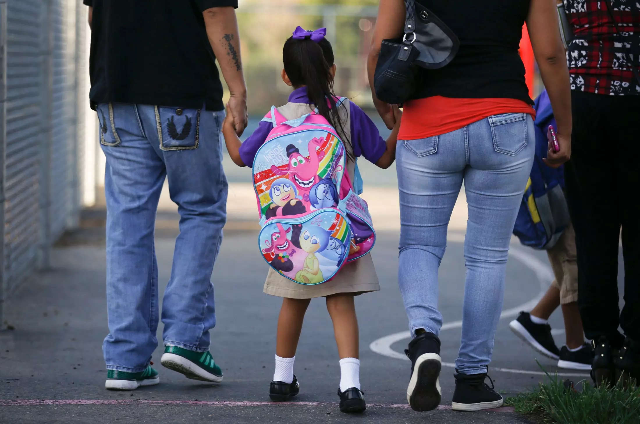 A couple walks their daughter to class on the first day of kindergarten in West Covina.