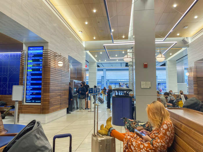 There were benches in front of screens with train schedules in the regular waiting area.