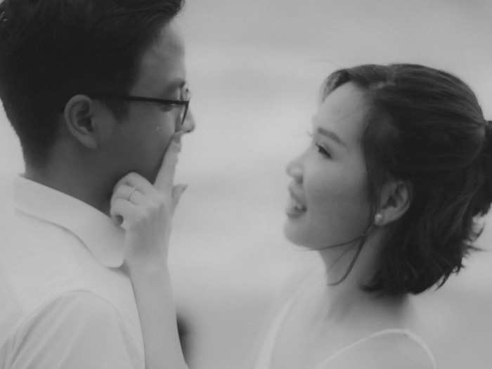 A bride-to-be wipes a tear from her fiancé’s cheek in Bali.