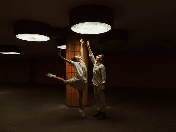 A couple in Berlin reaches for the light together.