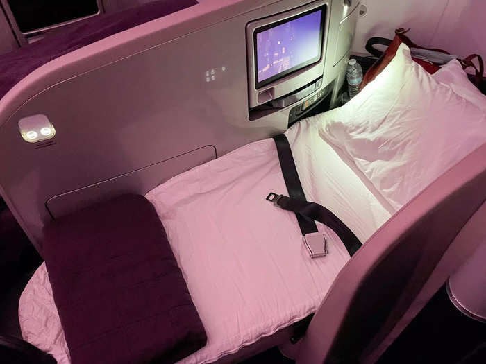 The biggest perk was that my business-class seat could turn into a lie-flat bed. After dinner service, flight attendants stopped by with extra blankets and pillows and converted my seat into a bed.