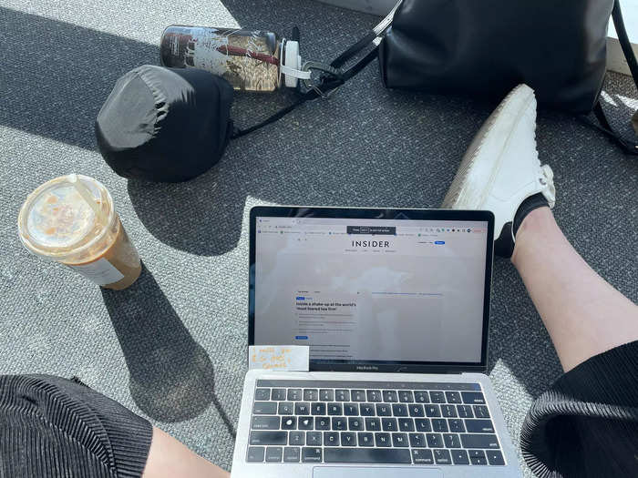 I searched the airport terminal for comfy seating — something the lounge had plenty of — but ultimately settled on sitting on the floor so I could stretch out before the flight.