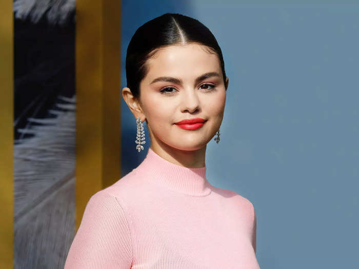 Selena Gomez said she felt "violated" when paparazzi photographed her as a teen.