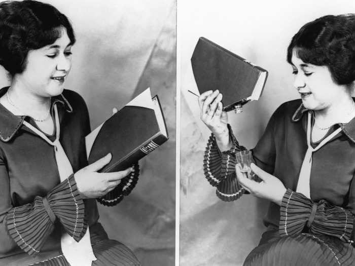 Here, a woman demonstrates how to use a Prohibition-era book, which was made to hide a liquor flask.