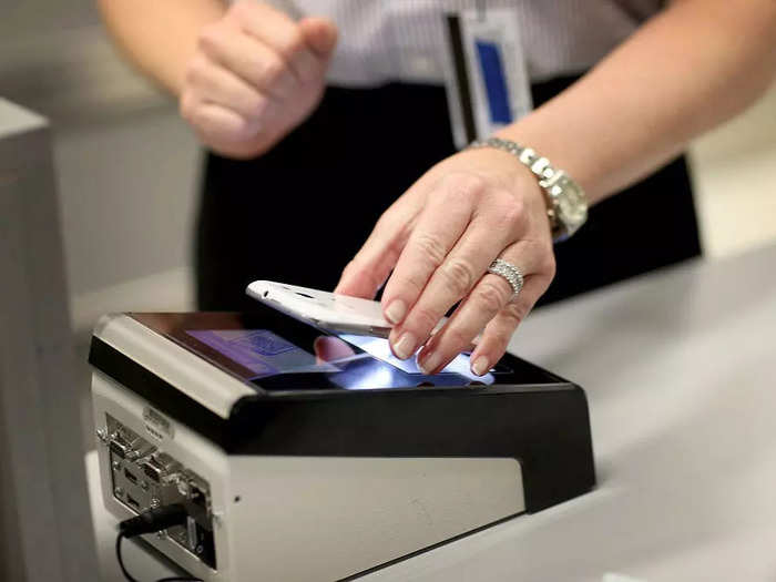 Gate agents still print paper boarding passes, but many people use e-tickets on their phones.