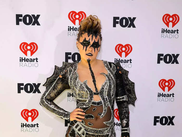 She wore her most shocking outfit to date at the 2024 iHeartRadio Music Awards. It included a mesh bodysuit decorated with pearl and sequin patterns, a plunging neckline, and long sleeves lined with wing-like pieces.