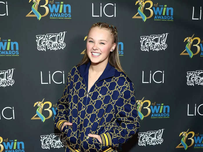 Today, Siwa is known to have a designer wardrobe filled with Gucci pieces. She wore a track jacket and matching shorts for a red carpet in October 2021.