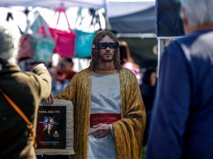 A cardboard cutout of Jesus featuring solar eclipse viewing glasses at the Carbondale Spring Fest in Illinois.