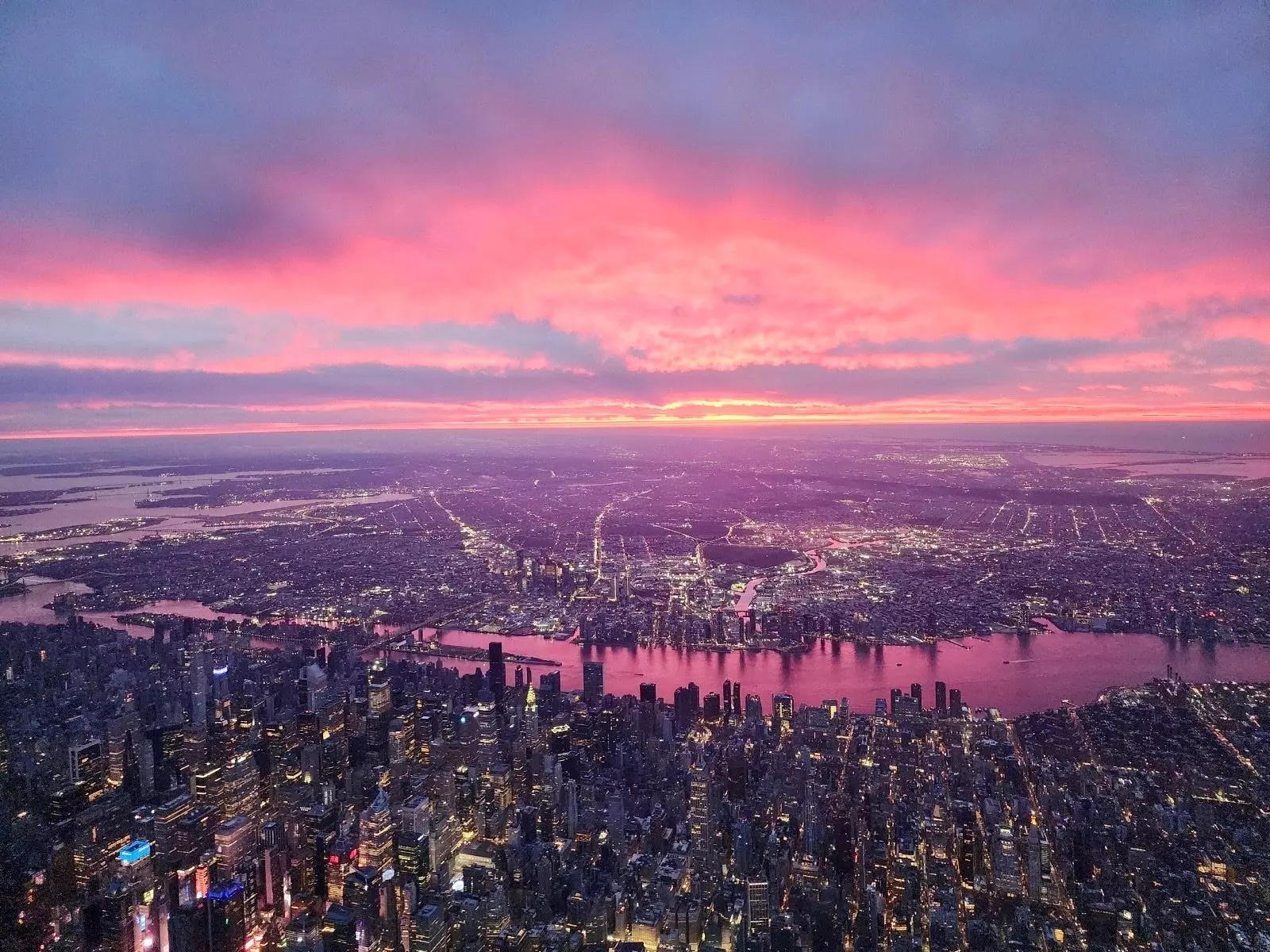 Pink skies over NYC from a plane.