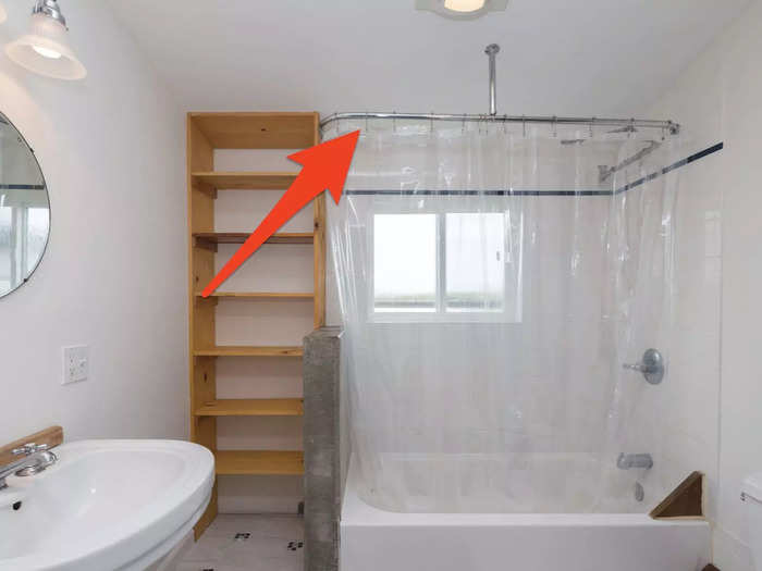 Hang your shower curtain high to draw the eye upward.