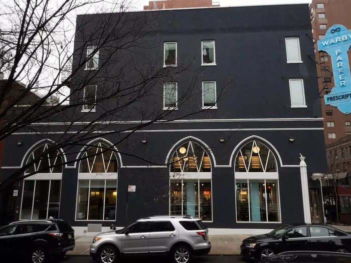 Warby Parker took over the building, painting it charcoal grey but keeping the original sign advertising prescriptions.