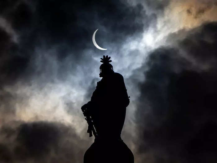 The eclipse was visible in the sky next to the Statue of Freedom on the top of the Capitol dome.