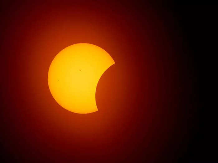 A photo taken in Fort Worth, Texas, shows the moon beginning to eclipse the sun around midday.