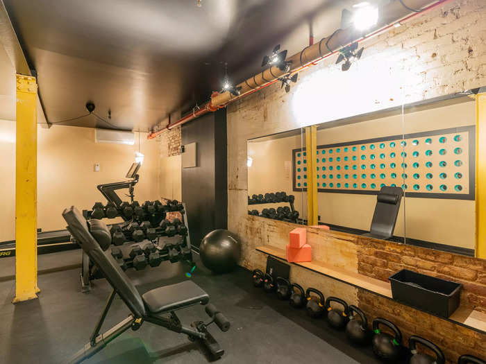 Common areas include a large ground-floor kitchen, a gym, and three outdoor decks. 