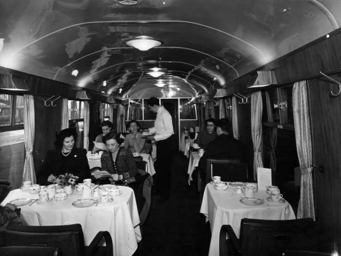 In 1951, waitstaff served food and drinks in a first-class dining saloon on a train at Marylebone Station in London.