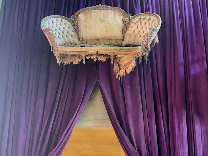 The lobby was flanked by regal purple drapes and a floating sofa that looked straight from the Victorian era.