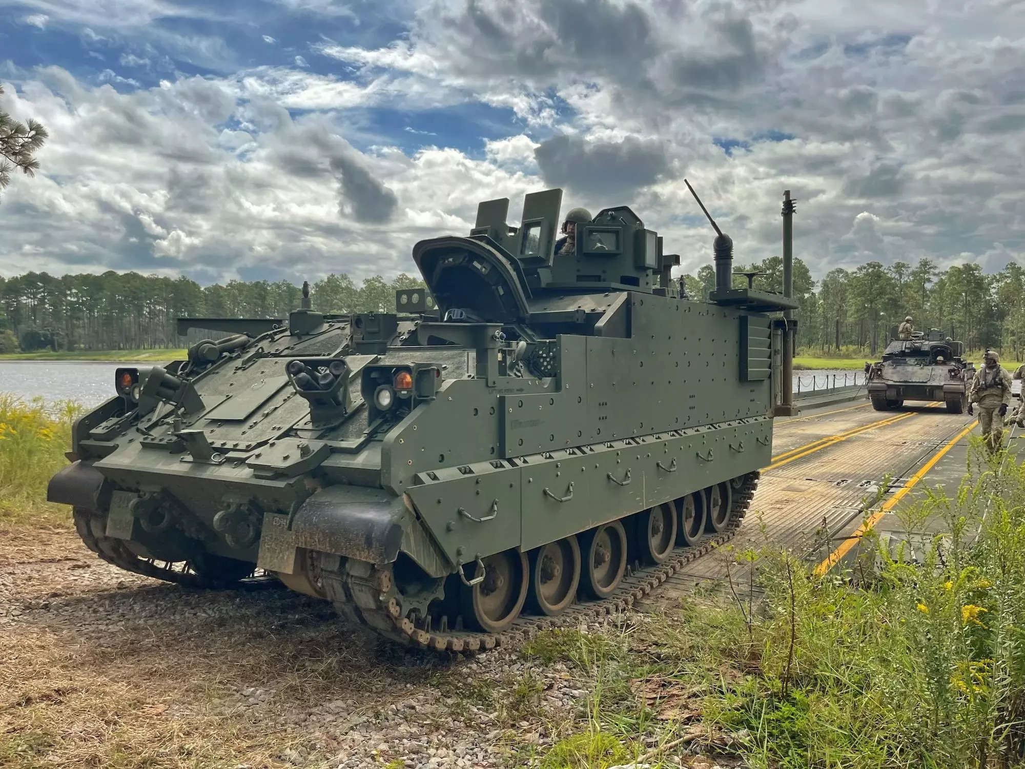 A 3rd Infantry Division Armored Multi-Purpose Vehicle drives off of a 497th Multi-Role Bridge Company, 92nd Engineer Battalion barge on Sept. 21, 2023.