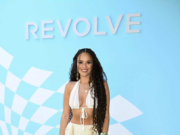 Madison Pettis paired see-through pants with a bikini top at Revolve Fest.