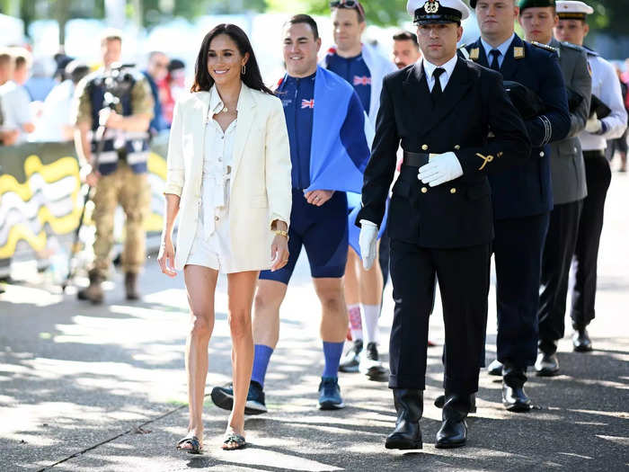Meghan also paired a Celine blazer with a Zara jumpsuit for an all-white look during the games. The shorts were a departure from her more conservative and formal royal attire, highlighting how much her style has changed since her step back.