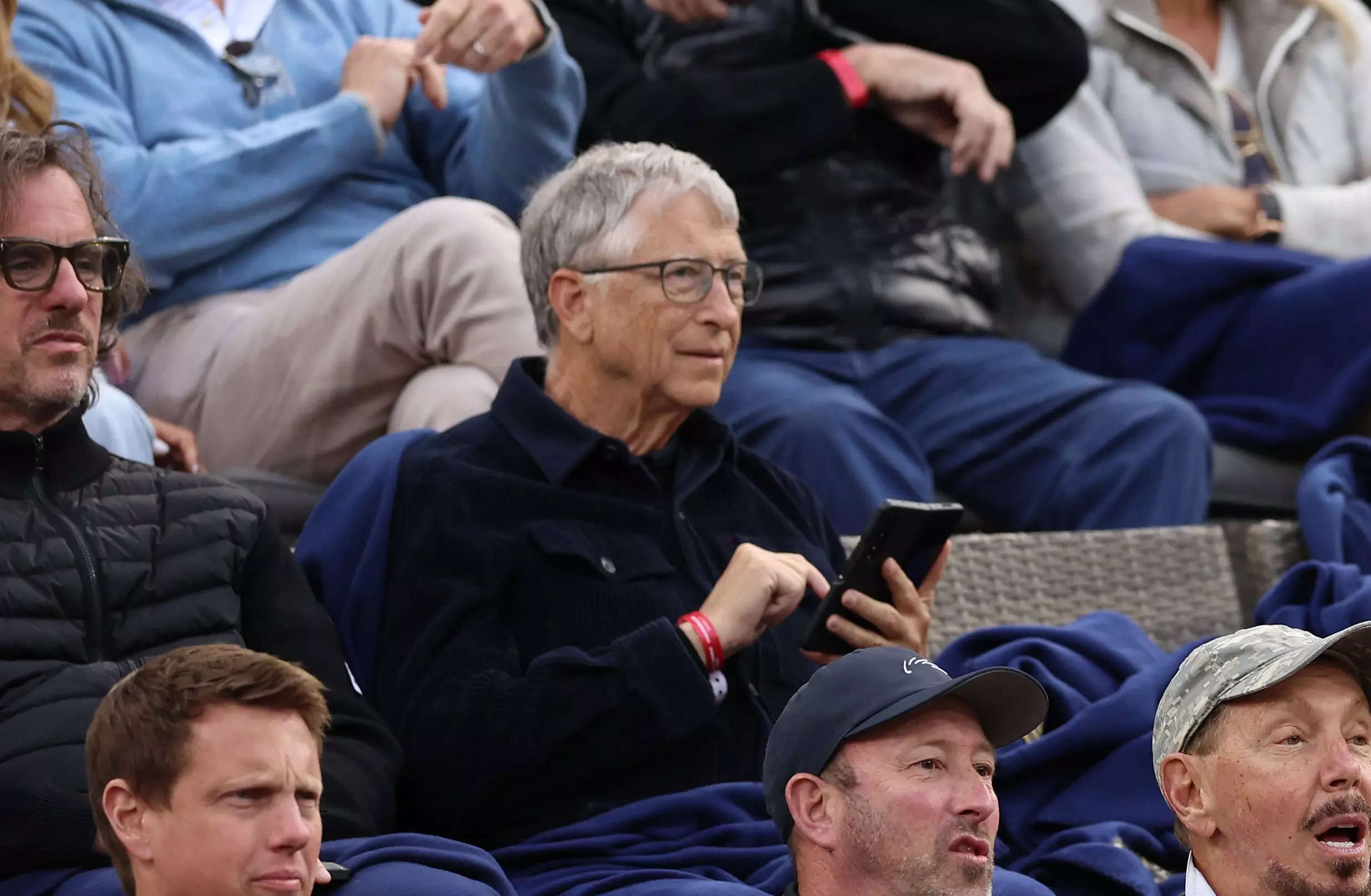 Bill Gates and Larry Ellison sitting in a crowd