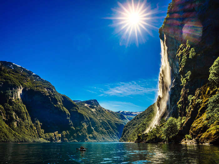 In the warmer months, lush greenery is offset by deep blue waters in Geiranger Fjord in Møre og Romsdal County, Norway.