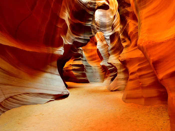 Antelope Canyon in Arizona is known for its wave-like patterns and tall sandstone walls.