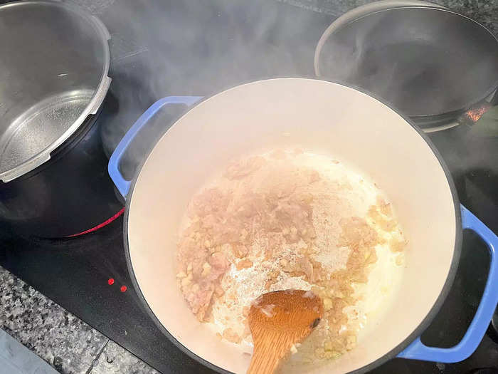 I placed my Dutch oven over medium-high heat and added two tablespoons of olive oil. Then, I added my shallots and garlic to the pan.