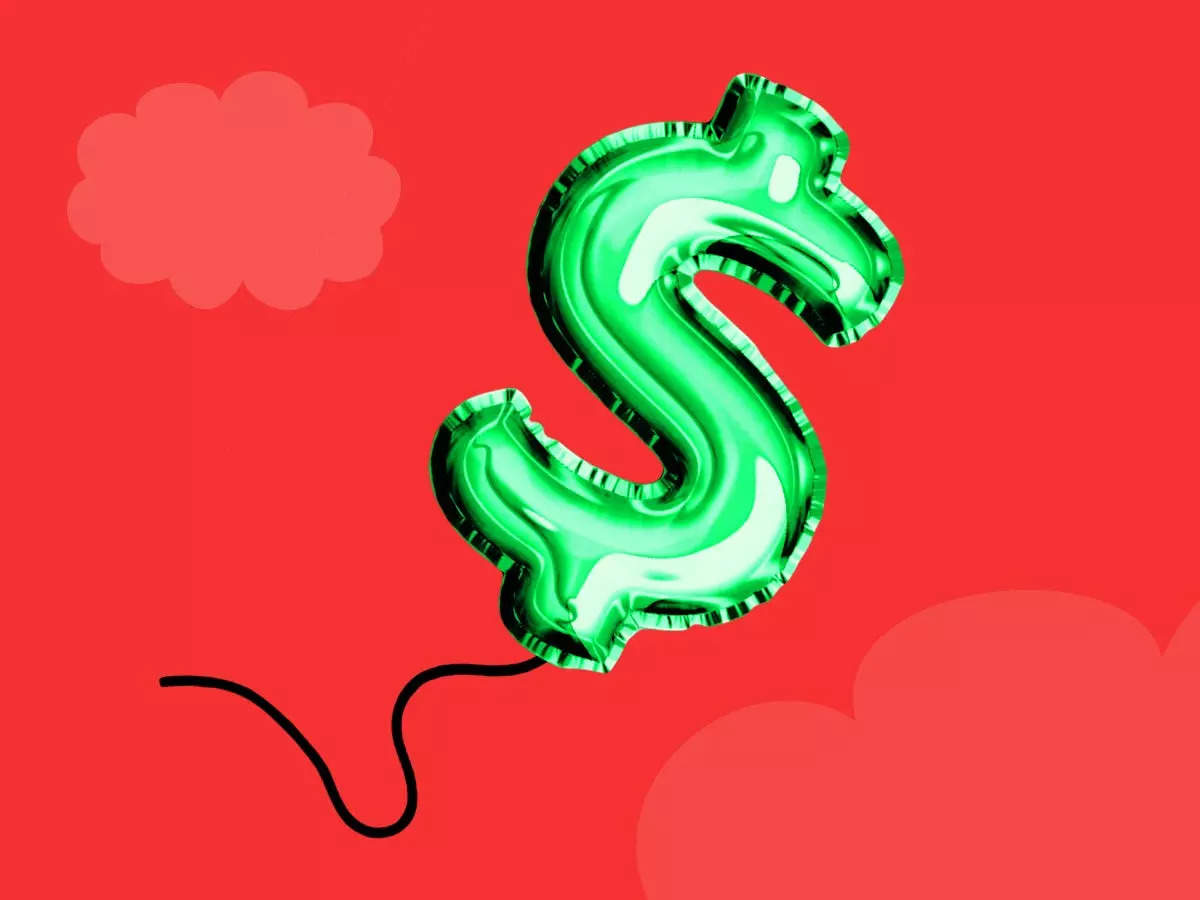 A dollar-sign balloon floating against a red background.