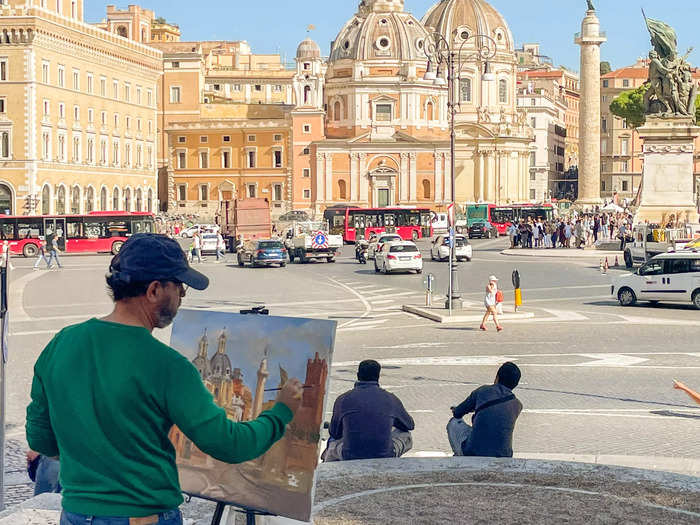 While exploring the city on foot, I remember spotting two alluring street artists. Under the shade of a tree near the Roman Forum, I watched an artist paint a chapel across the street.