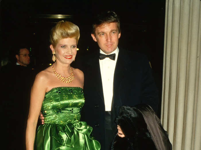 She wore a strapless green gown accessorized with red jewelry, a red clutch, and red lipstick in 1987 while her then-husband carried a fur coat.