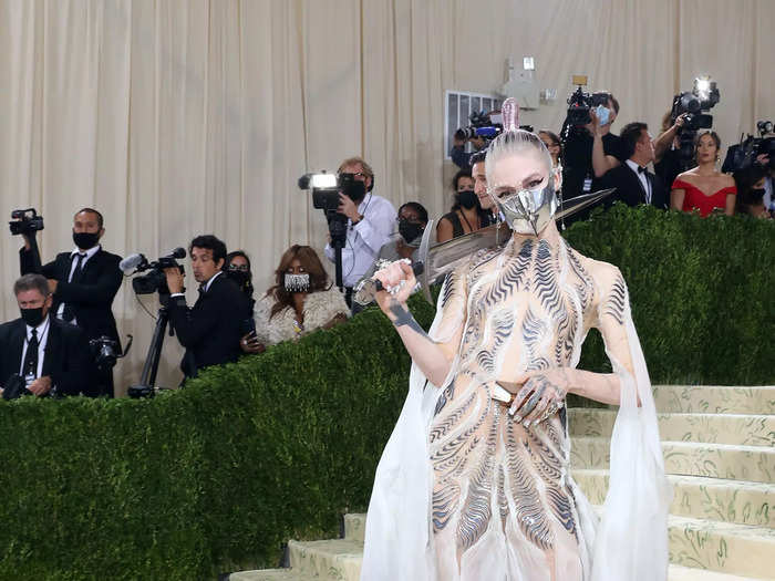 Grimes accessorized her Iris Van Herpen dress with a sword.